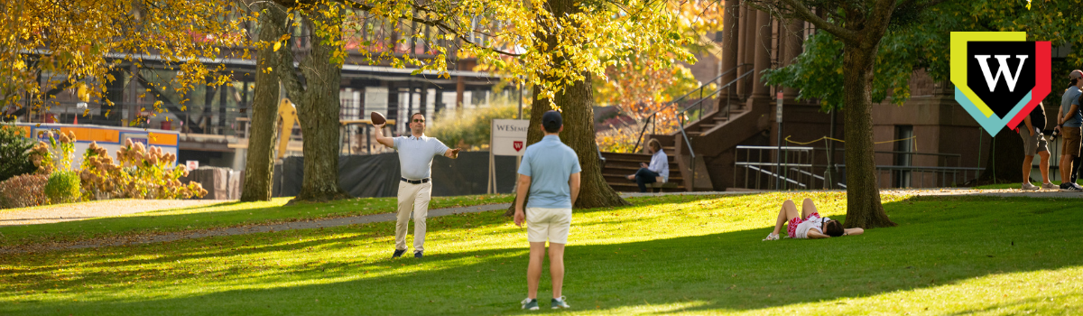 Two people playing catch on College Row